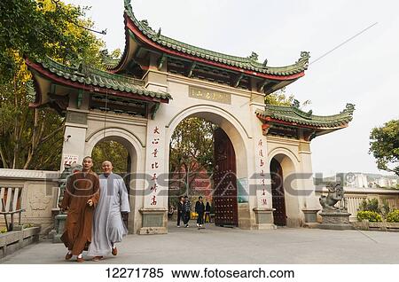 Two monks leaving Nan Pu Tuo buddhist temple; Xiamen, Fujian Province, China View Large Photo Image Stock Photography - Two monks leaving Nan Pu Tuo buddhist temple; Xiamen, Fujian Province, China. Fotosearch