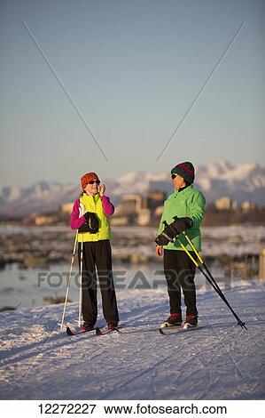 Two people cross country skiing on the Tony Knowles Coastal Trail with Anchorage in the background, Southcentral Alaska View Large Photo Image Stock Photo - Two people cross country skiing on the Tony Knowles Coastal Trail with Anchorage in the background, Southcentral Alaska. Fotosearch