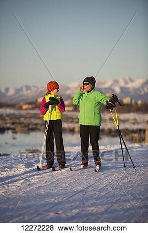 Two people cross country skiing on the Tony Knowles Coastal Trail with Anchorage in the background, Southcentral Alaska View Large Photo Image Stock Photo - Two people cross country skiing on the Tony Knowles Coastal Trail with Anchorage in the background, Southcentral Alaska. Fotosearch