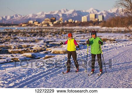 Two people cross country skiing on the Tony Knowles Coastal Trail with Anchorage in the background, Southcentral Alaska View Large Photo Image Stock Photo - Two people cross country skiing on the Tony Knowles Coastal Trail with Anchorage in the background, Southcentral Alaska. Fotosearch