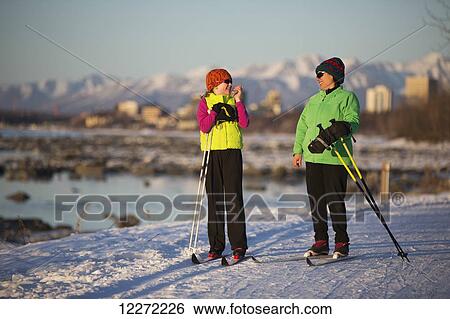 Two people cross country skiing on the Tony Knowles Coastal Trail with Anchorage in the background, Southcentral Alaska View Large Photo Image Stock Photograph - Two people cross country skiing on the Tony Knowles Coastal Trail with Anchorage in the background, Southcentral Alaska. Fotosearch