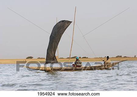 Picture - Two people on Sail boat at the Niger River between Mopti and Lake Debo, Mali. Fotosearch