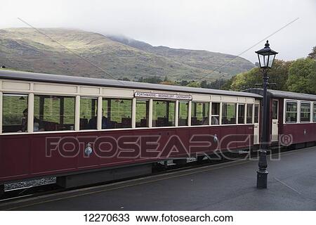 Stock Image - Two train cars with passengers; Rhyd Ddu, Gwynedd, Wales. Fotosearch
