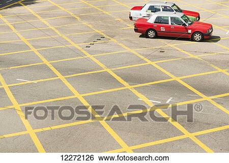 Stock Photograph - Two typical red taxis on the road; Hong Kong Island, Hong Kong, China. Fotosearch