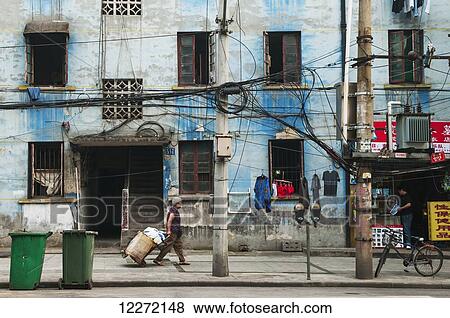 Typical street with weathered old buildings and tangled electrical wires; Wuhan, Hubei province, China View Large Photo Image Stock Photo - Typical street with weathered old buildings and tangled electrical wires; Wuhan, Hubei province, China. Fotosearch