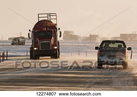 Vac truck and pickup truck driving on icy roads in the Prudhoe Bay Oil Field, Arctic Alaska, Winter View Large Photo Image Stock Photo - Vac truck and pickup truck driving on icy roads in the Prudhoe Bay Oil Field, Arctic Alaska, Winter. Fotosearch