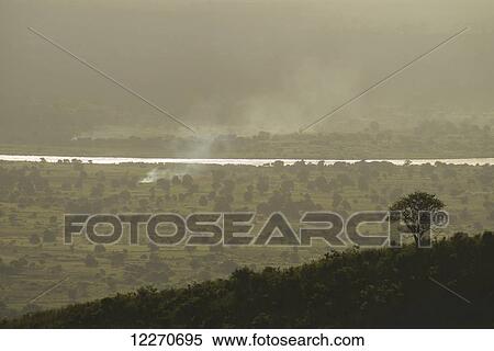 Stock Photography - View from hills down to plains around the Shire River at dusk; Malawi. Fotosearch