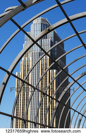 Stock Photograph - View of a skyscraper through a metal structure; Minneapolis, Minnesota, United States of America. Fotosearch