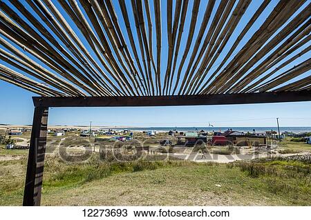 View of the beach and accommodation along the coast from under a pergola; Cabo Polonio, Uruguay View Large Photo Image Stock Image - View of the beach and accommodation along the coast from under a pergola; Cabo Polonio, Uruguay. Fotosearch