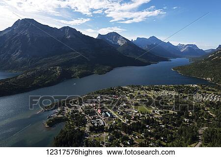 View of the buildings in the national park and the lake spanning the Rocky mountains, Waterton Lakes National Park; Alberta, Canada View Large Photo Image Stock Photograph - View of the buildings in the national park and the lake spanning the Rocky mountains, Waterton Lakes National Park; Alberta, Canada. Fotosearch