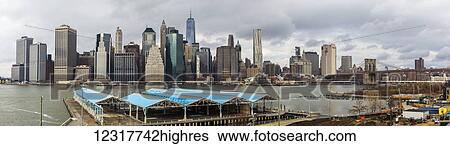 Stock Photograph - View of the New York City skyline and the Brooklyn Bridge from Brooklyn; New York City, New York, United States of America. Fotosearch