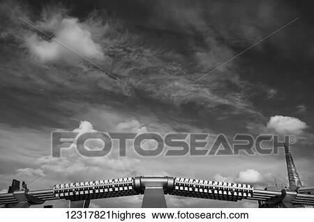Stock Photograph - View of the sky and The Shard from Millennium Bridge against a dramatic spring sky; London, England. Fotosearch
