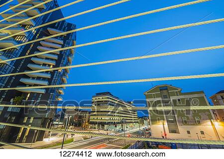 Stock Image - View through a railing of residential buildings; Milan, Lombardy, Italy. Fotosearch