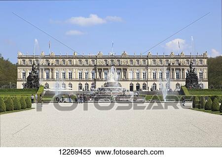 Stock Photography - Water fountains in front of a building with pedestrians; Die Herreninsel im Chiemsee, Bayern, Germany. Fotosearch