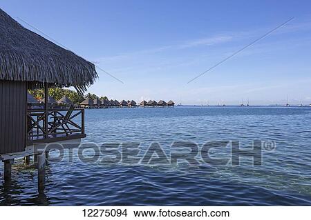 Picture - Waterfront hotel accommodation on stilts; Tahiti. Fotosearch