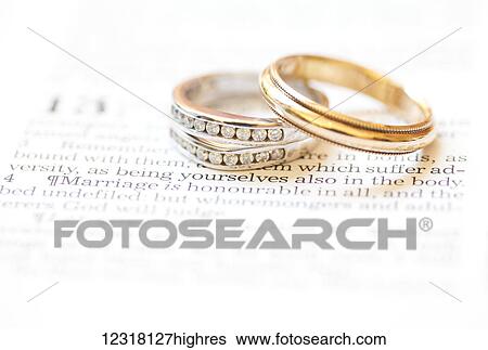 Stock Photograph - Wedding bands placed over the scripture Hebrews 13: 4; Waco, Texas, United States of America. Fotosearch