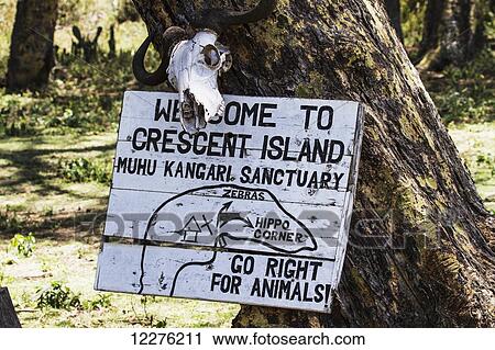 Stock Image - Welcome sign on Crescent Island, Lake Naivasha National Park; Kenya. Fotosearch