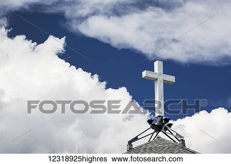 White cross on top of a peak roof with white clouds and deep blue sky; Calgary, Alberta, Canada View Large Photo Image Stock Photograph - White cross on top of a peak roof with white clouds and deep blue sky; Calgary, Alberta, Canada. Fotosearch