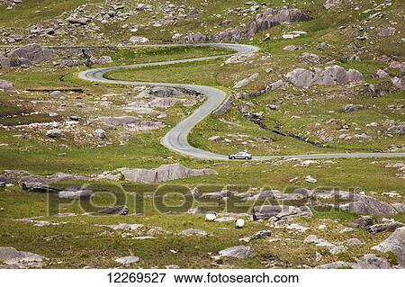 Winding road of Healy Pass through a rugged landscape of grass and rocks; County Cork, Ireland View Large Photo Image Stock Photo - Winding road of Healy Pass through a rugged landscape of grass and rocks; County Cork, Ireland. Fotosearch