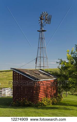 Stock Photo - Windmill and red corn crib, near Edgewood; Iowa, United States of America. Fotosearch