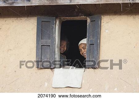 Stock Image - Woman At The Window Of A House Along The Road Between Ambositra & Ambavalao, Fianarantsoa Province, Madagascar. Fotosearch