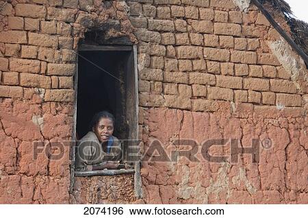Stock Photograph - Woman At The Window Of A House Along The Road Between Ambositra & Ambavalao, Fianarantsoa Province, Madagascar. Fotosearch