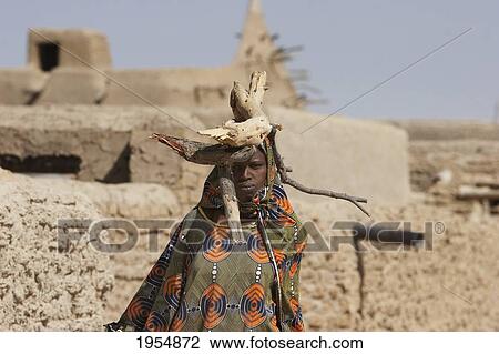 Woman carrying branches on her head in Sebi, Mali View Large Photo Image Stock Image - Woman carrying branches on her head in Sebi, Mali. Fotosearch