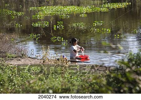 Woman Doing Laundry In A Lagoon Near Carmen Ruiz, Santa Cruz Department, Bolivia View Large Photo Image Picture - Woman Doing Laundry In A Lagoon Near Carmen Ruiz, Santa Cruz Department, Bolivia. Fotosearch