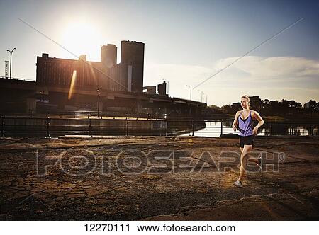 Woman going for a run in an urban environment; Montreal, Quebec, Canada View Large Photo Image Stock Image - Woman going for a run in an urban environment; Montreal, Quebec, Canada. Fotosearch
