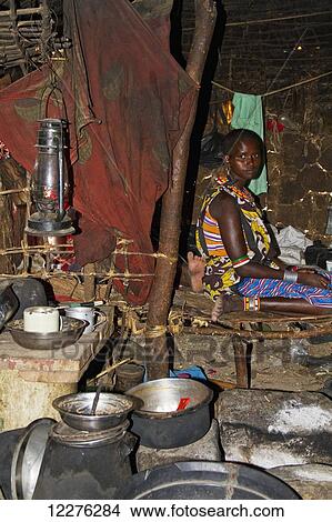 Picture - Woman in the interior of a Samburu hut; Samburu County, Kenya. Fotosearch