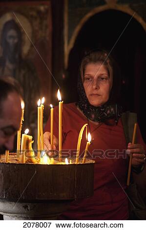 Woman Lighting Candles In The Church Of St. Nicholas, Kotor, Monte View Large Photo Image Stock Photo - Woman Lighting Candles In The Church Of St. Nicholas, Kotor, Monte. Fotosearch