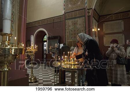 Woman Lighting Devotional Candles In The Alexander Nevsky Cathedral At Tallinn, Estonia View Large Photo Image Stock Photograph - Woman Lighting Devotional Candles In The Alexander Nevsky Cathedral At Tallinn, Estonia. Fotosearch