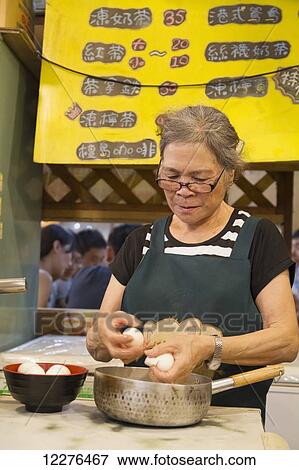 Woman peeling eggs at the night market; Hualien, Taiwan View Large Photo Image Stock Photo - Woman peeling eggs at the night market; Hualien, Taiwan. Fotosearch