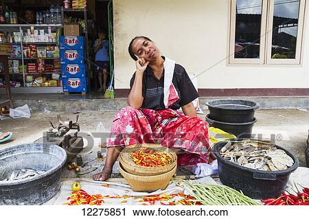 Stock Image - Woman selling hot peppers at the weekly market, Semparu, Lombok, West Nusa Tenggara, Indonesia. Fotosearch
