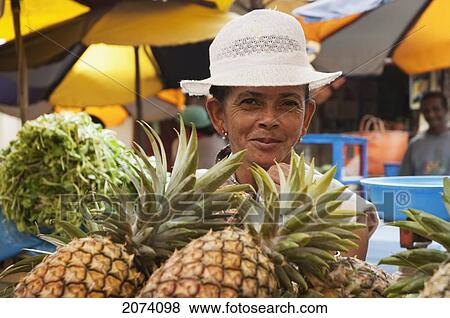 Woman Selling Pineapples At An Antananarivo Market, Antananarivo Province, Madagascar View Large Photo Image Stock Photo - Woman Selling Pineapples At An Antananarivo Market, Antananarivo Province, Madagascar. Fotosearch