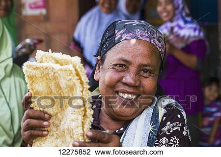 Woman selling rice cakes at the weekly market, Semparu, Lombok, West Nusa Tenggara, Indonesia View Large Photo Image Stock Image - Woman selling rice cakes at the weekly market, Semparu, Lombok, West Nusa Tenggara, Indonesia. Fotosearch
