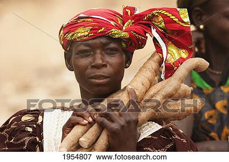 Stock Photo - Woman selling taro roots along the Bamako-Djenne Road, Mali. Fotosearch