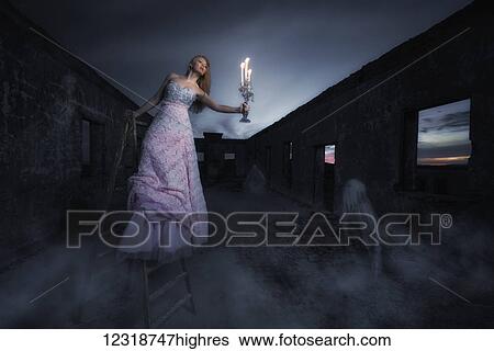 Stock Photograph - Woman surrounded by ghosts; Tarifa, Cadiz, Costa de la Luz, Andalusia, Spain. Fotosearch