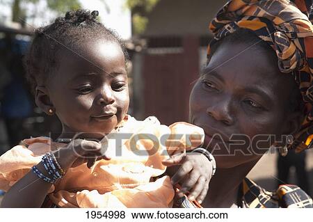 Woman with her daughter in Bamako, Mali View Large Photo Image Stock Photo - Woman with her daughter in Bamako, Mali. Fotosearch