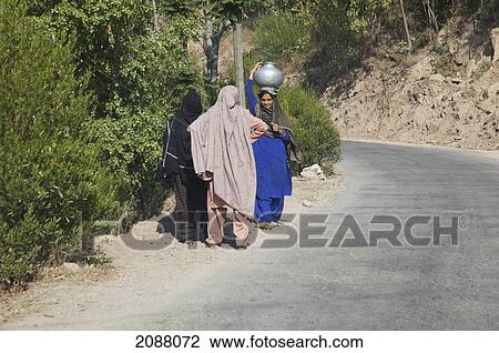 Stock Image - Women On A Road After The 8 October 2005 Earthquake, Dhirkot, Azad Kashmir, Pakistan. Fotosearch