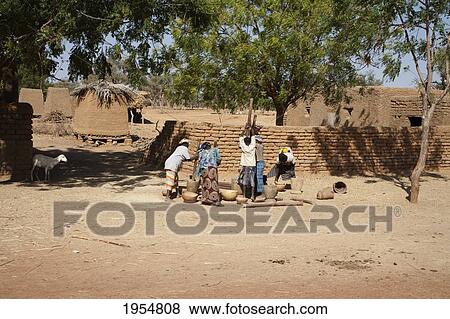 Women pounding millet in a village on the Bamako-Djenne Road, Mali View Large Photo Image Stock Photo - Women pounding millet in a village on the Bamako-Djenne Road, Mali. Fotosearch
