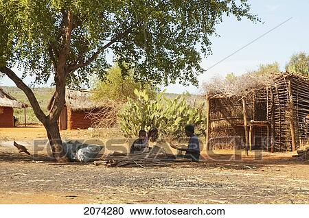 Stock Image - Women Preparing Food In An-Za Mpirahalahy, Toliara Province, Madagascar. Fotosearch