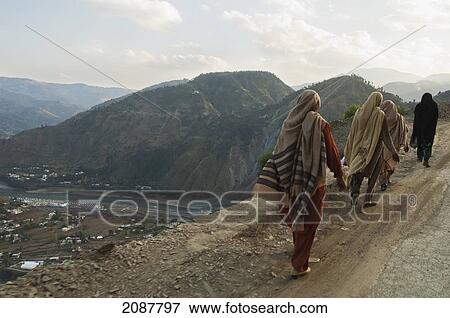 Stock Photo - Women Walking On A Road After The 8 October 2005 Earthquake, Muzaffarabad, Azad Kashmir, Pakistan. Fotosearch