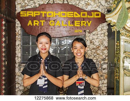 Stock Photo - Women welcoming guests at the entrance of Saptohoedojo Art Gallery, Yogyakarta, Java Island, Indonesia. Fotosearch