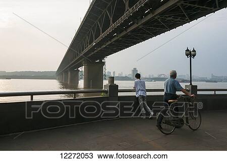 Wuhan Bridge crossing Yangtze river at sunset; Wuhan, Hubei province, China View Large Photo Image Stock Image - Wuhan Bridge crossing Yangtze river at sunset; Wuhan, Hubei province, China. Fotosearch