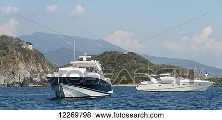 Yachts in the water off the coast; Ixtapa-Zihuatanejo, Guerrero, Mexico View Large Photo Image Stock Photo - Yachts in the water off the coast; Ixtapa-Zihuatanejo, Guerrero, Mexico. Fotosearch