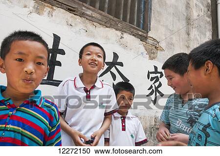 Stock Image - Young boys playing beside their school in a small village near Wuyuan; Jiangxi province, China. Fotosearch