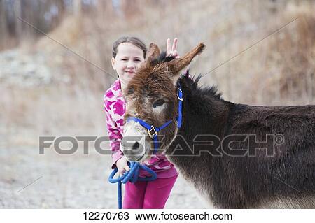 Young girl walking a pet donkey near Palmer in Southcentral Alaska, Spring View Large Photo Image Stock Image - Young girl walking a pet donkey near Palmer in Southcentral Alaska, Spring. Fotosearch