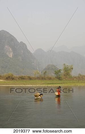Stock Photo - Young Girls Gathering Seaweed, Laos. Fotosearch