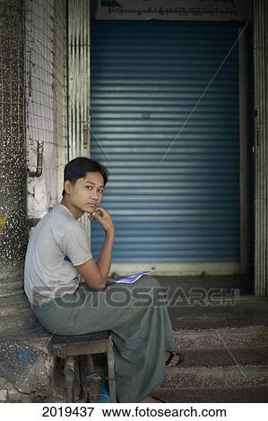 Young Man Sitting, Yangon, Myanmar (Burma) View Large Photo Image Stock Photo - Young Man Sitting, Yangon, Myanmar (Burma). Fotosearch